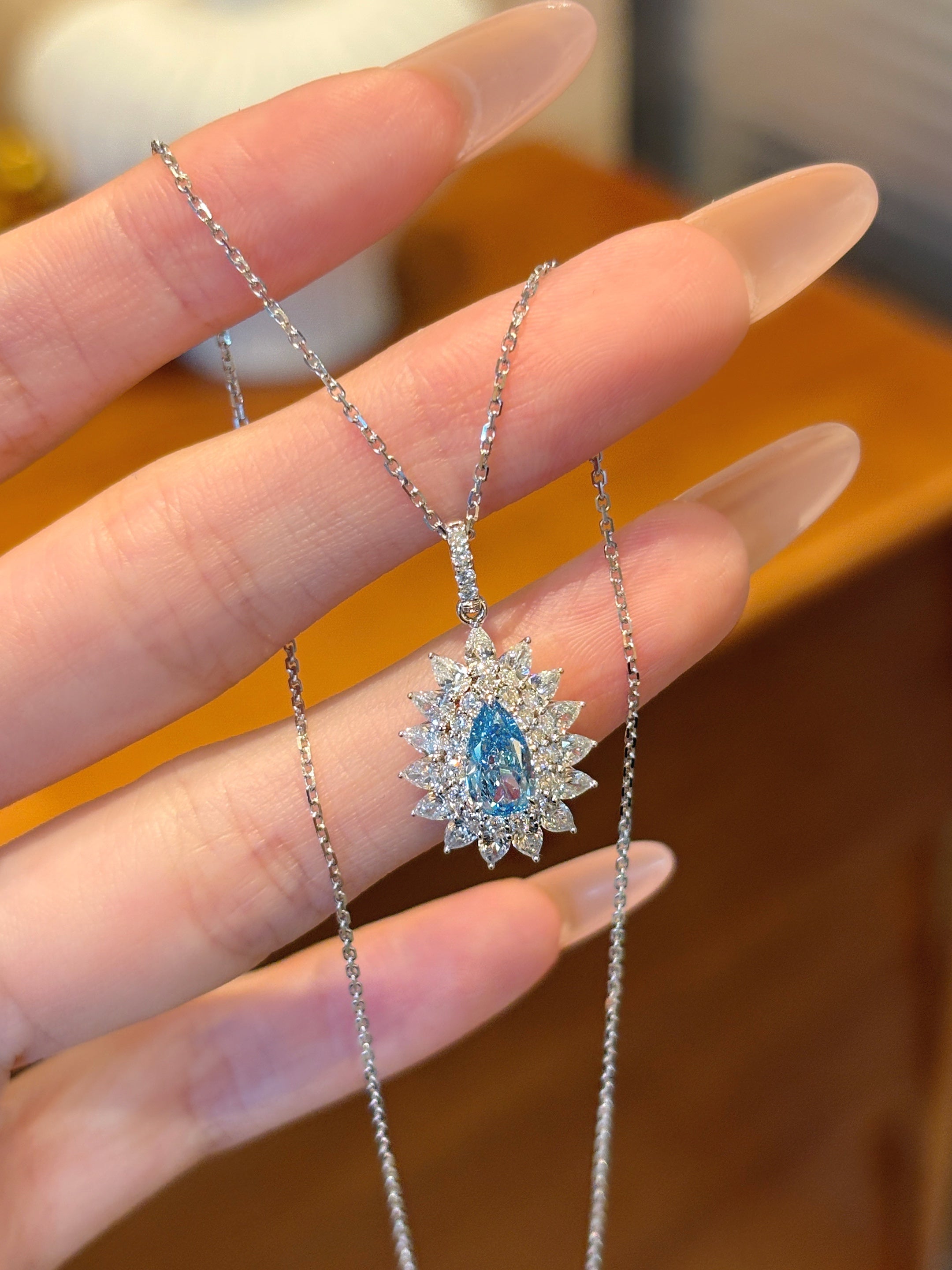 Pear Shape Blue Gemstone Halo Diamond Necklace | Radiant Teardrop Pendant with Marquise & Round Cut Diamond Accents | Platinum Finish