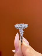 Deposit  for nicki 18k Marquise center stone, 5 carats, with approximately 0.33 carats of side stones, featuring a petal-style setting D/vvs2